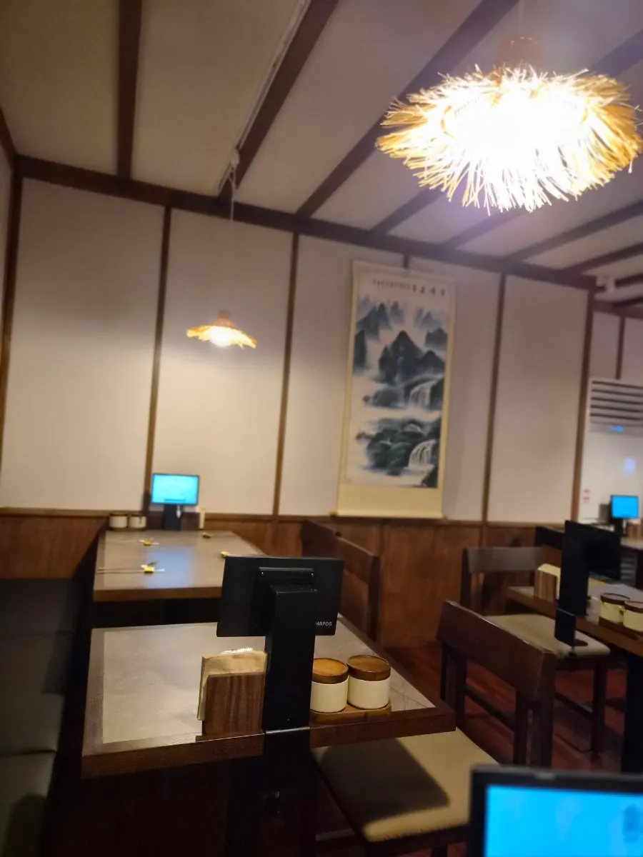 Anok's interior with wood-toned tables and soft lighting