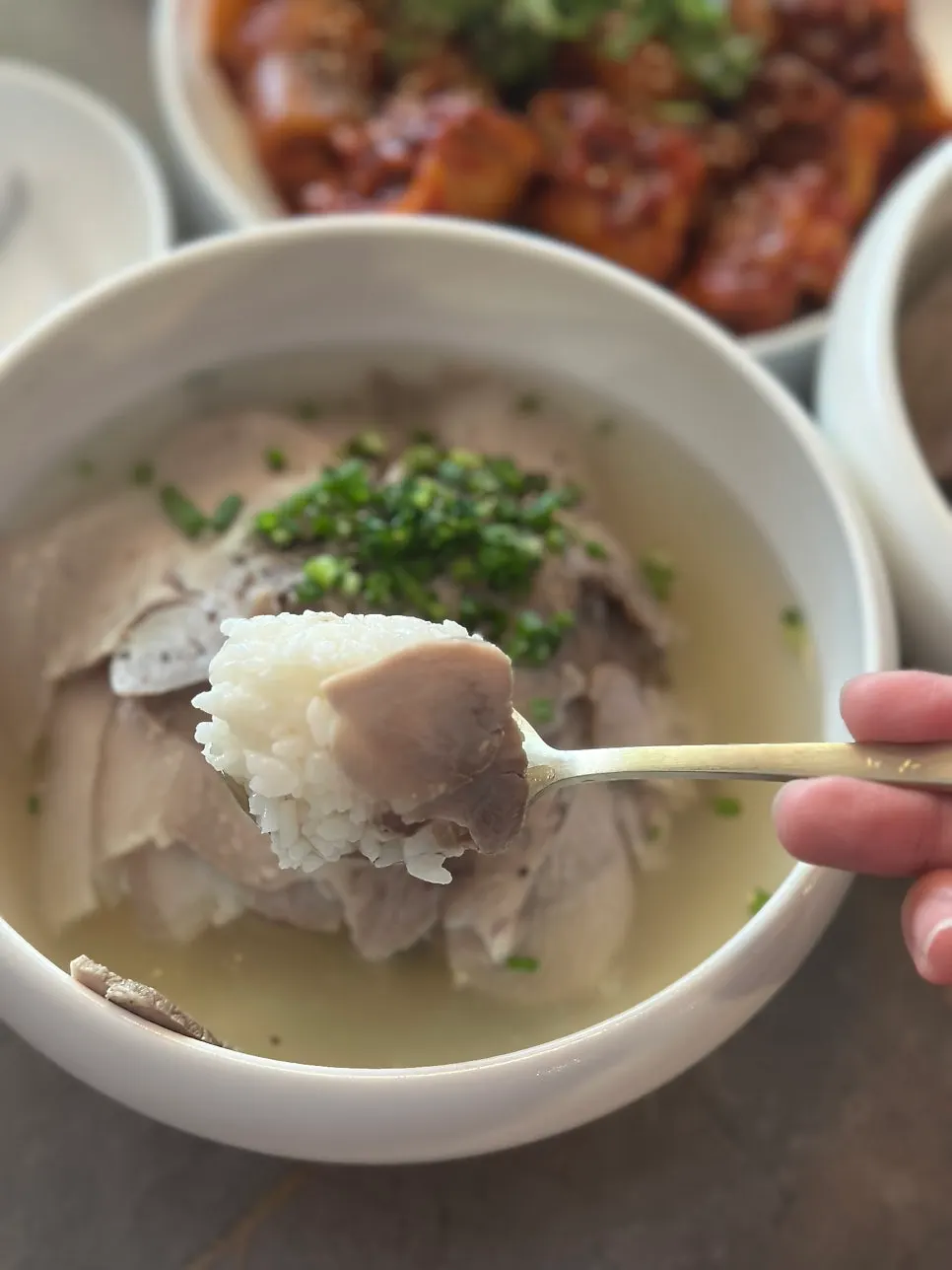 A bowl of Anok's pork gomtang topped with whole cuts of meat