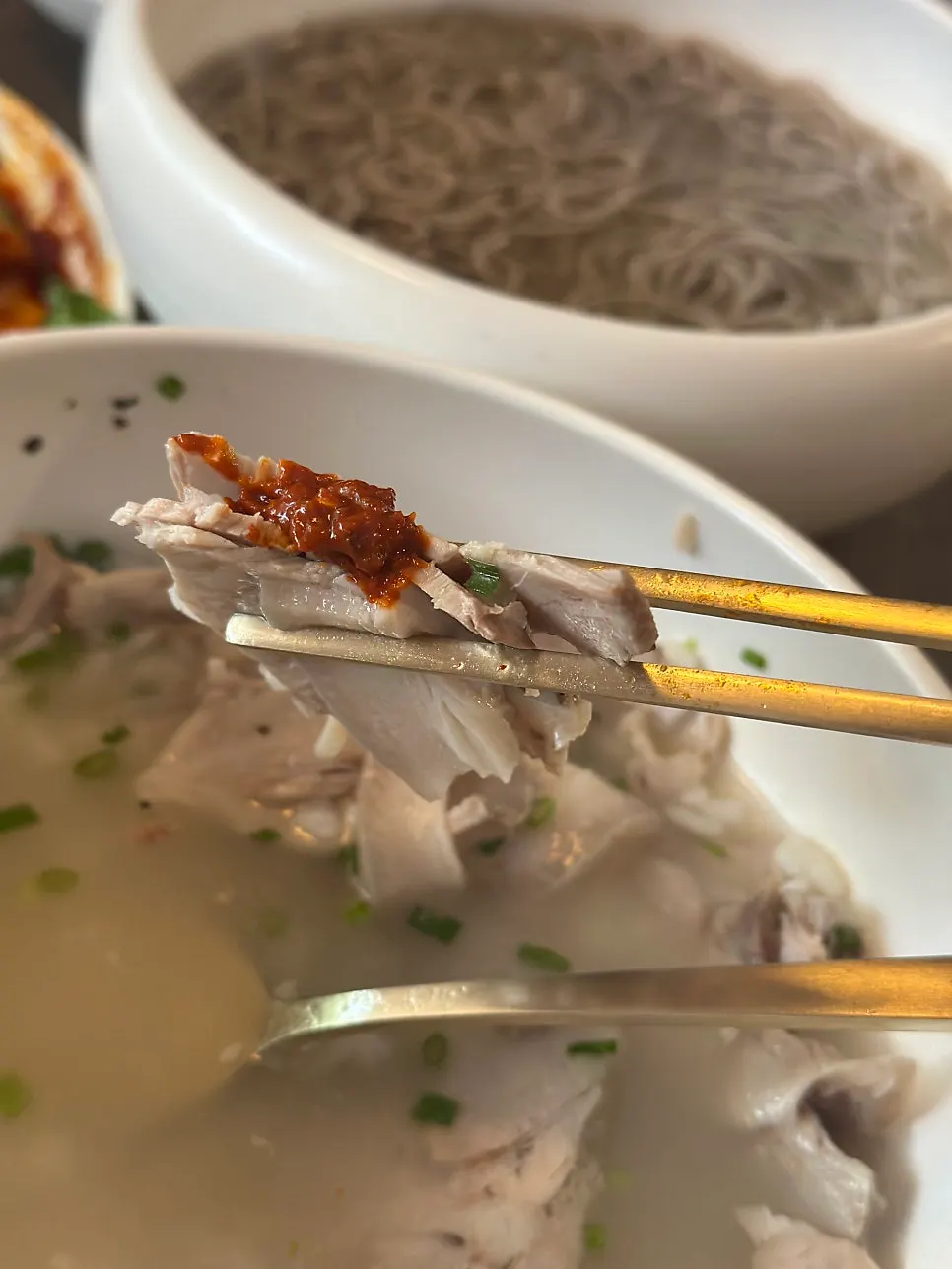 Dipping a piece of Anok's meat in the sauce