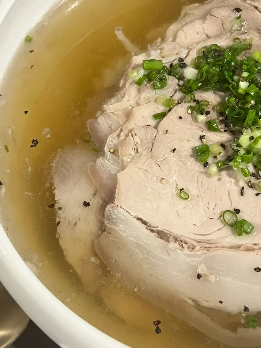 A bowl of Anok's menu with spoon and chopsticks