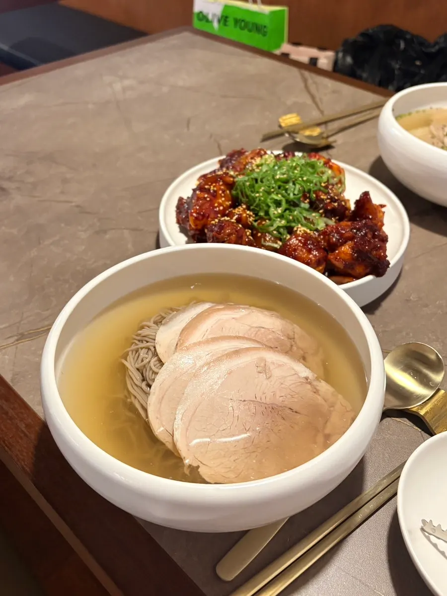 Toppings and buckwheat noodles over clear broth