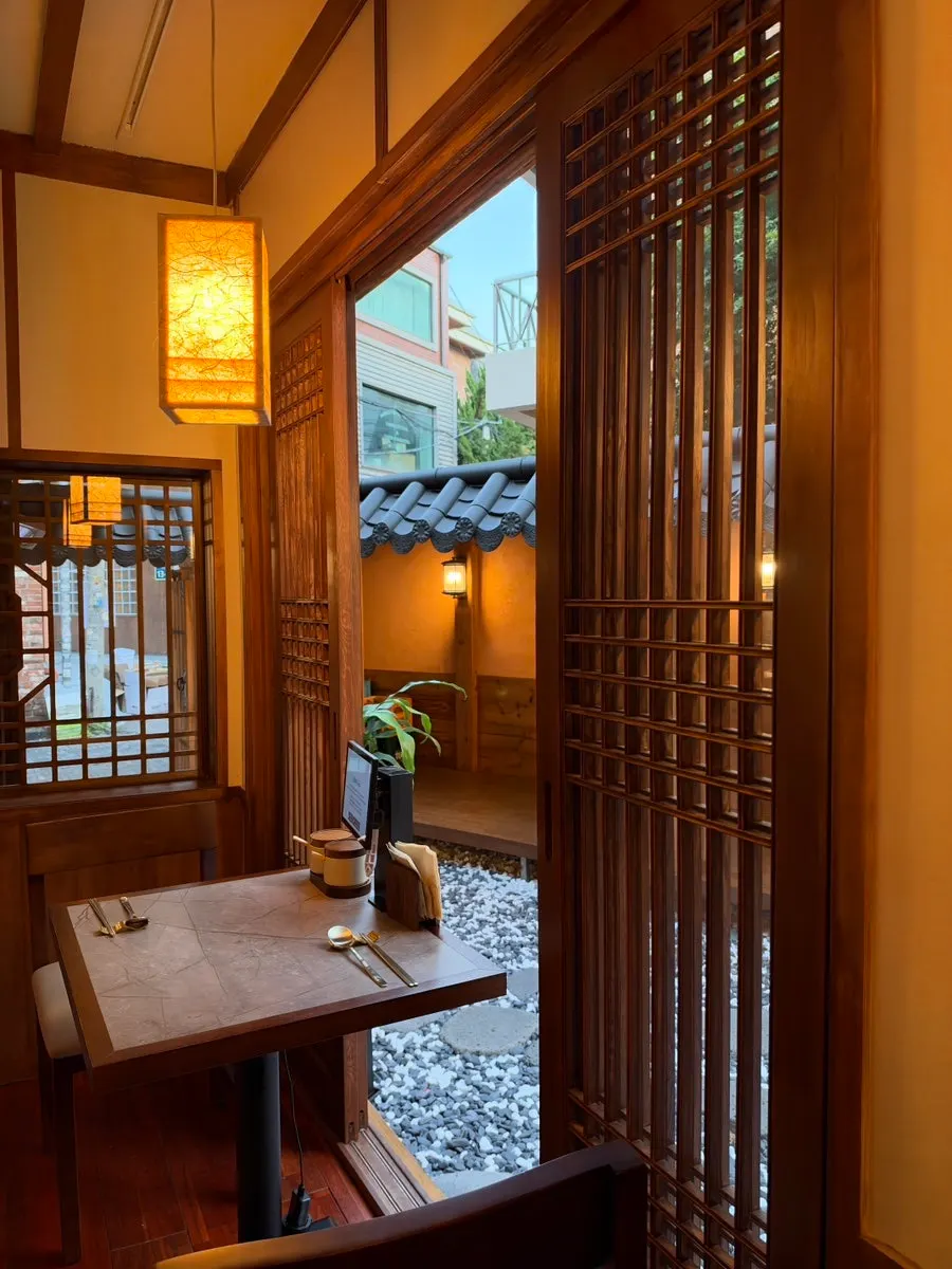 Anok's interior with wood-toned furniture and lighting