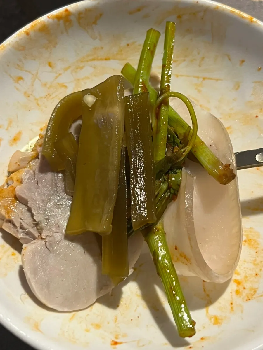 A piece of naengje-yuk topped with minari