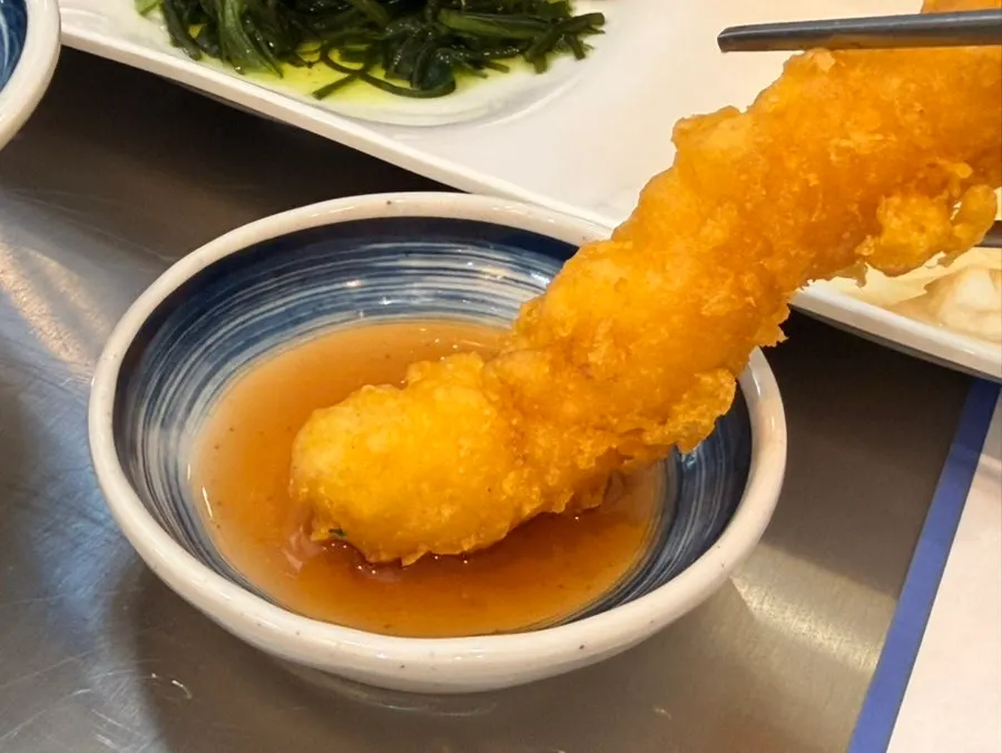 Shrimp fritter dipped in soy sauce