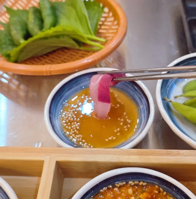 Salmon sashimi with sauce and onions
