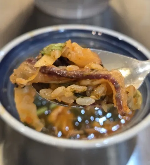 Close-up of hoe-deopbap piled with raw fish