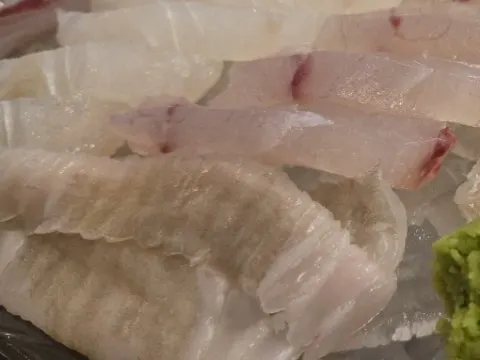 Picking up a piece of sashimi