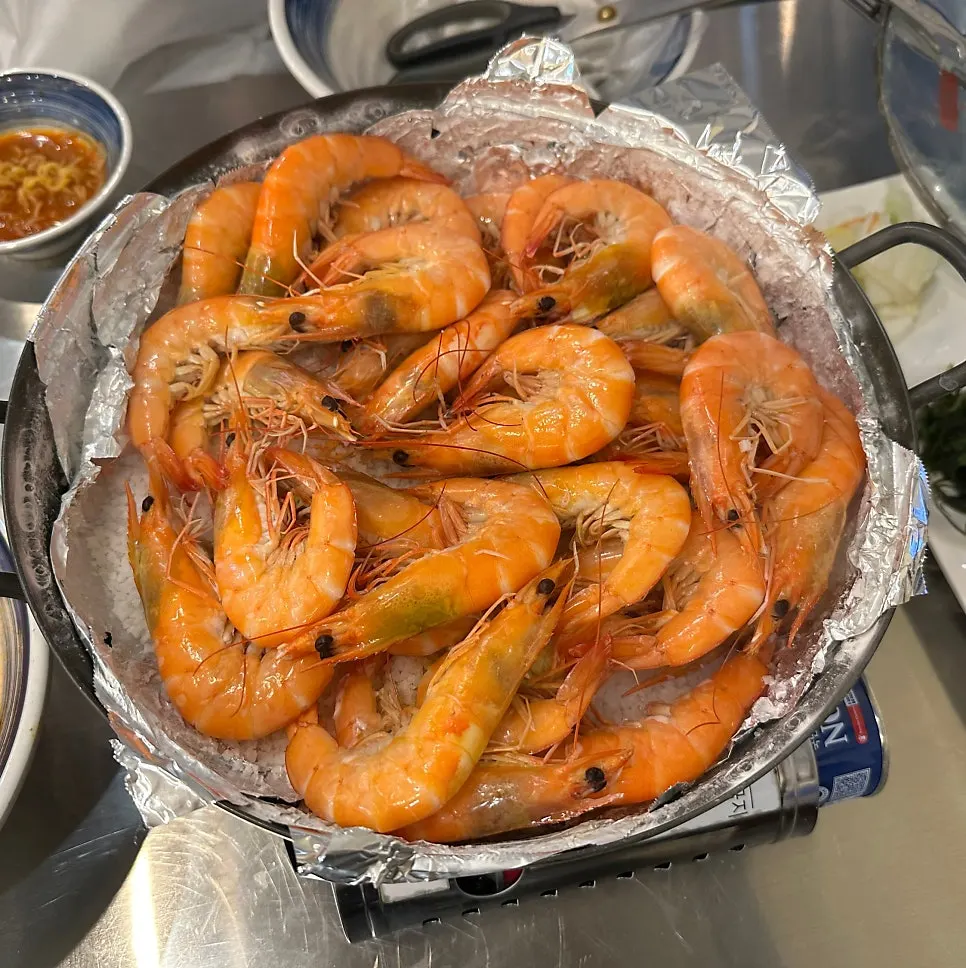 Shrimp grilled red on a bed of salt