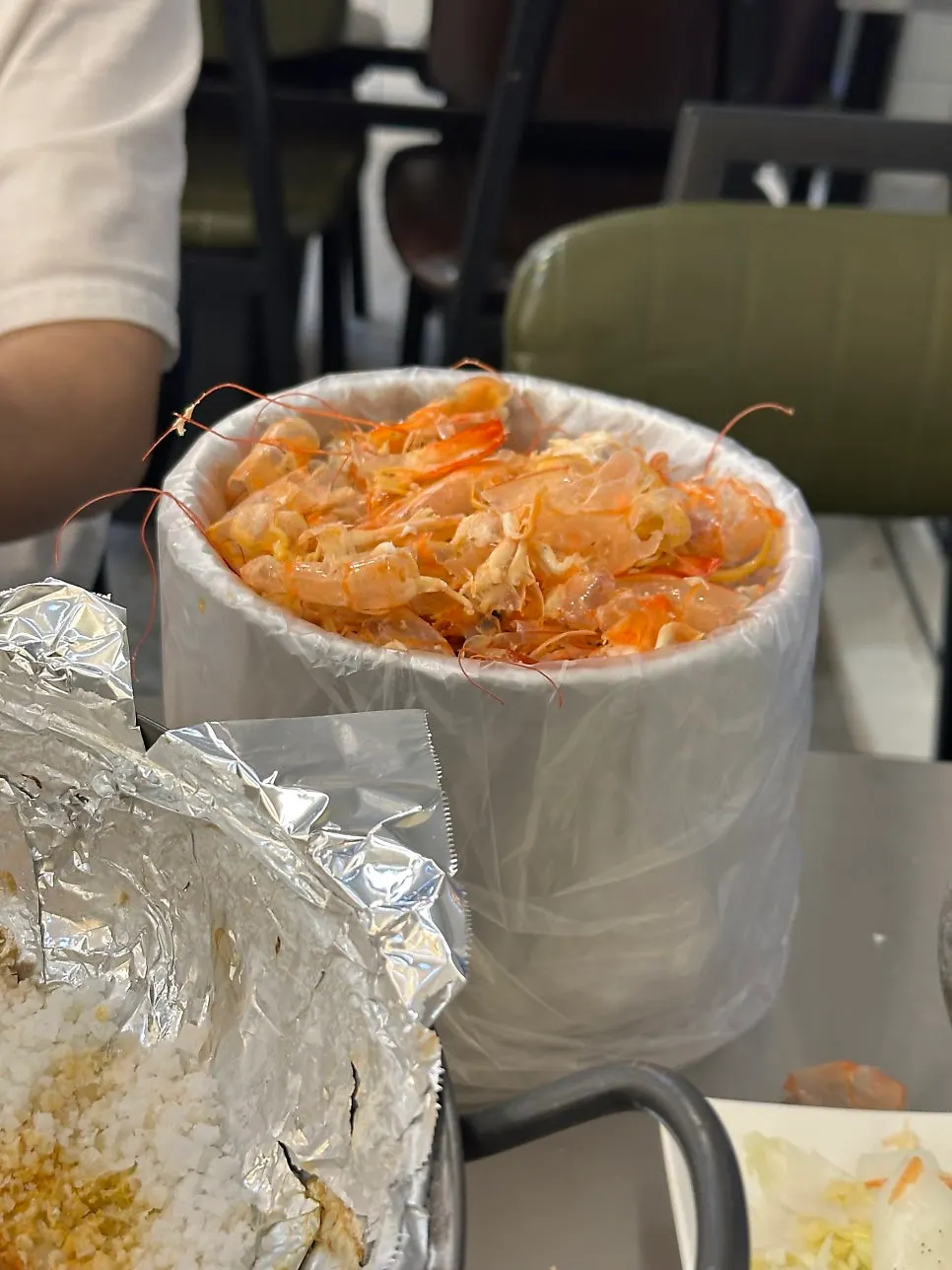 A plate piled with peeled shrimp meat