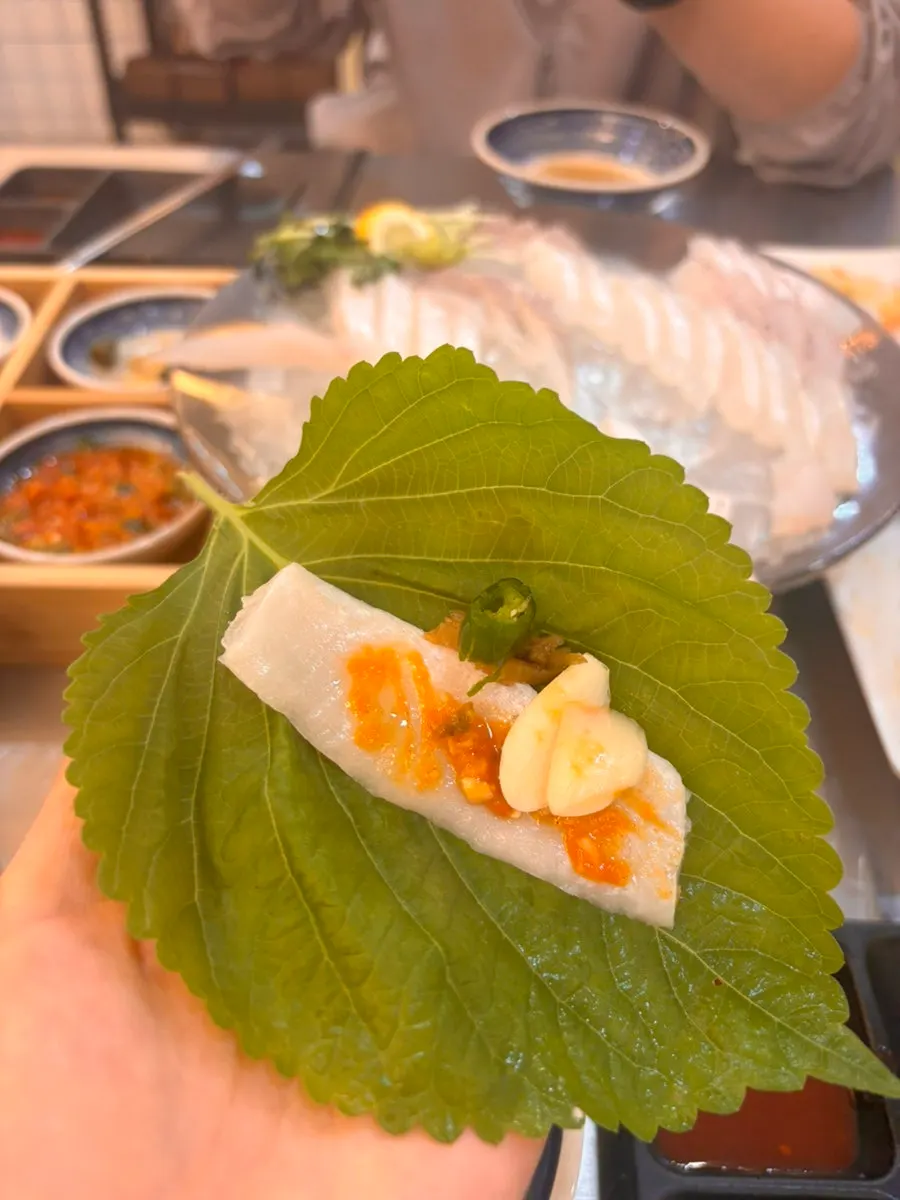 Various dipping sauces with a piece of sashimi