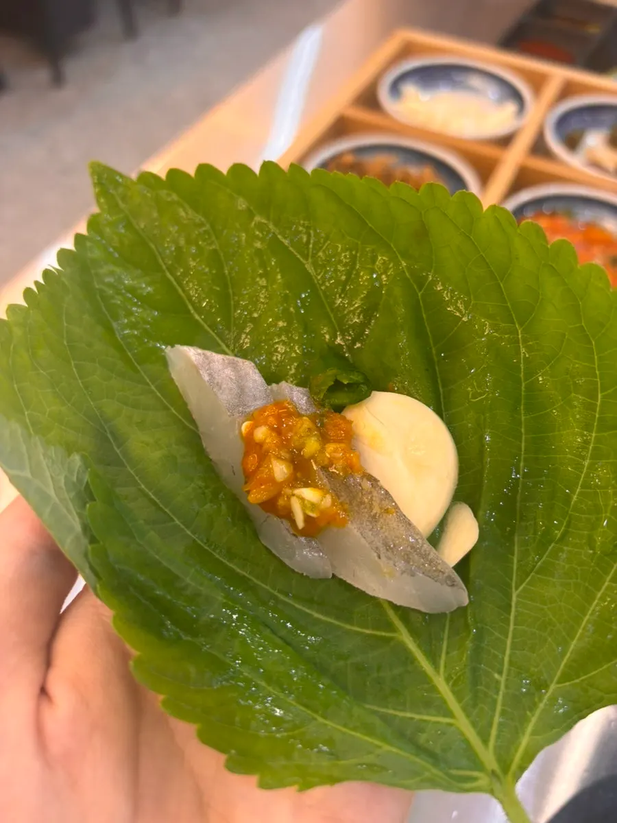 Sashimi dipped in wasabi soy sauce