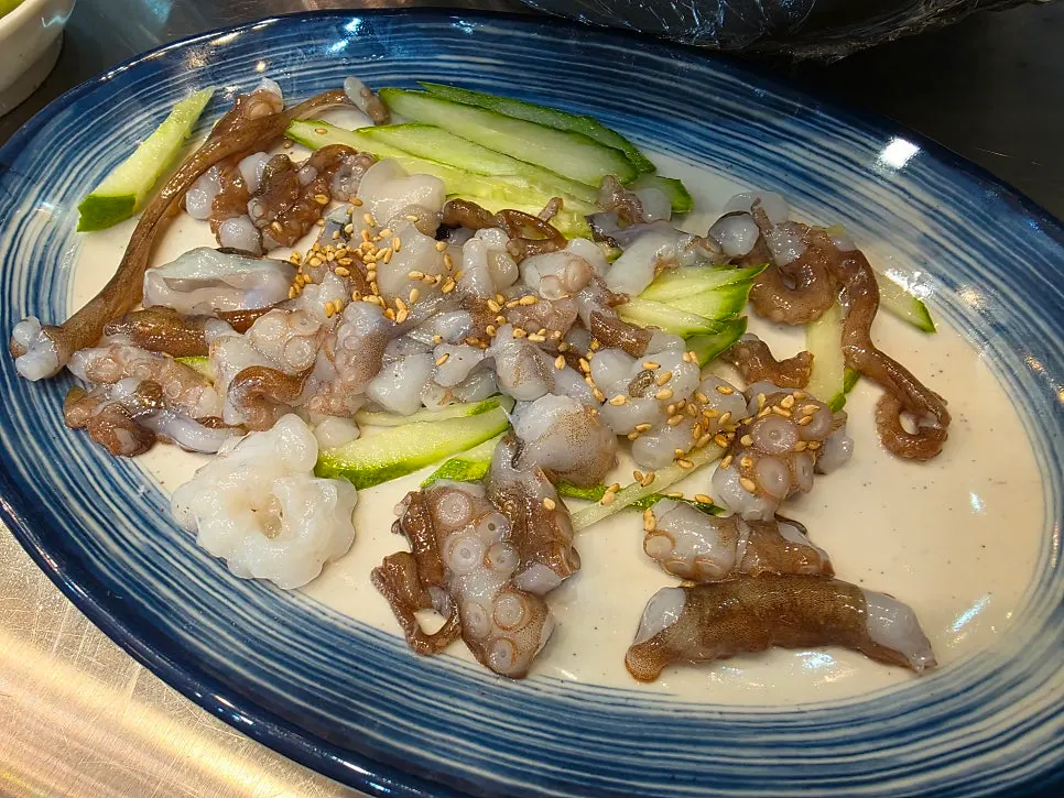 Table set with both live octopus and mixed sashimi
