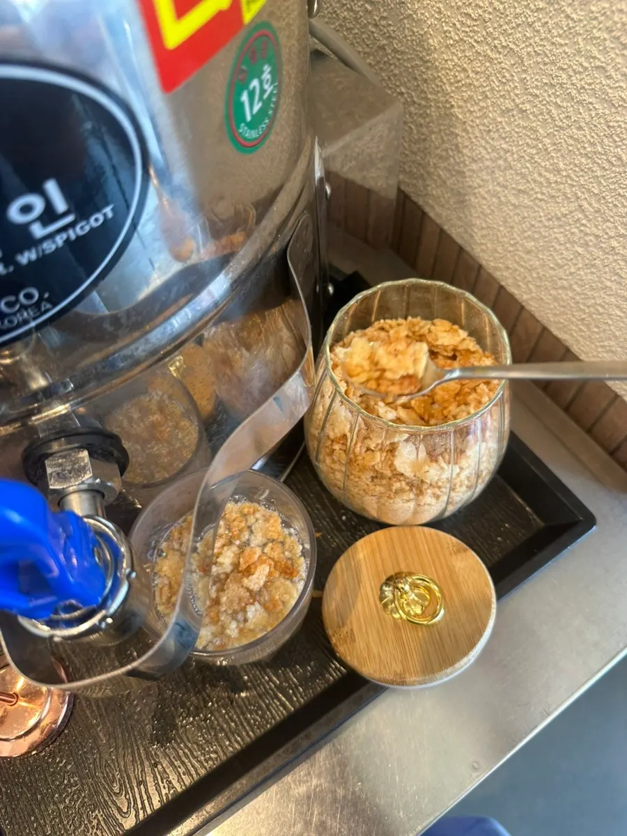 Self-serve bar with side dishes and scorched rice