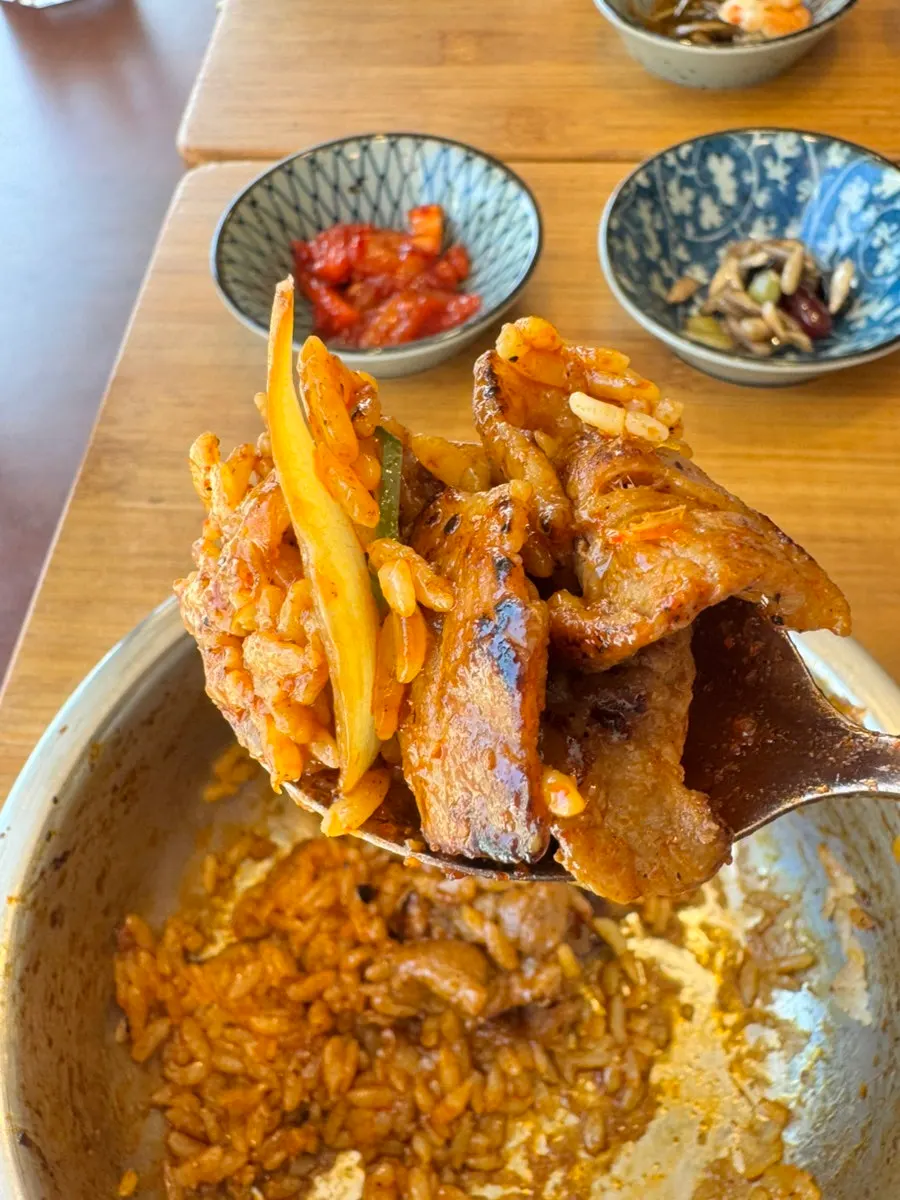 A spoonful of pot rice lifted up