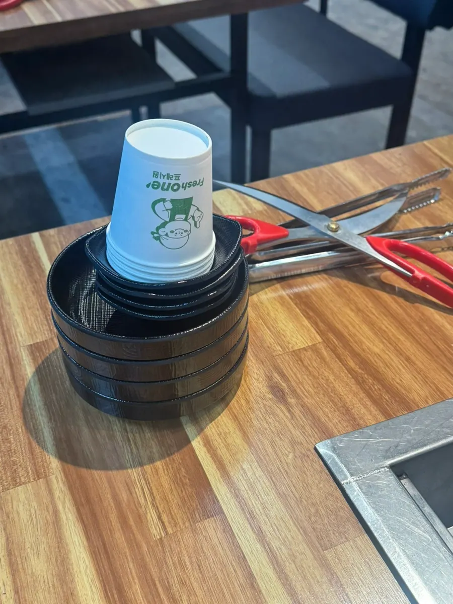 Table setting with small plates, paper cups, scissors, and tongs