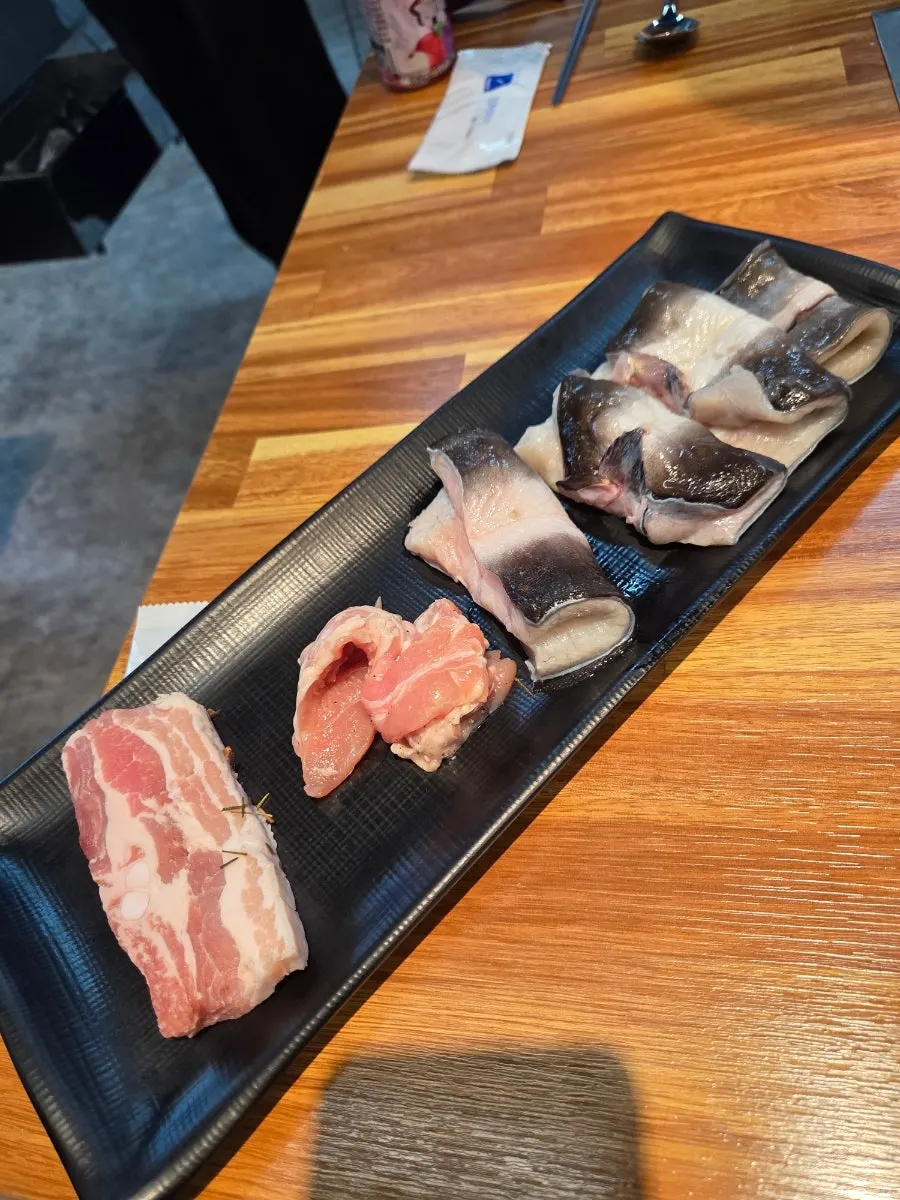 Freshwater eel, pork belly, and chicken neck brought on a plate