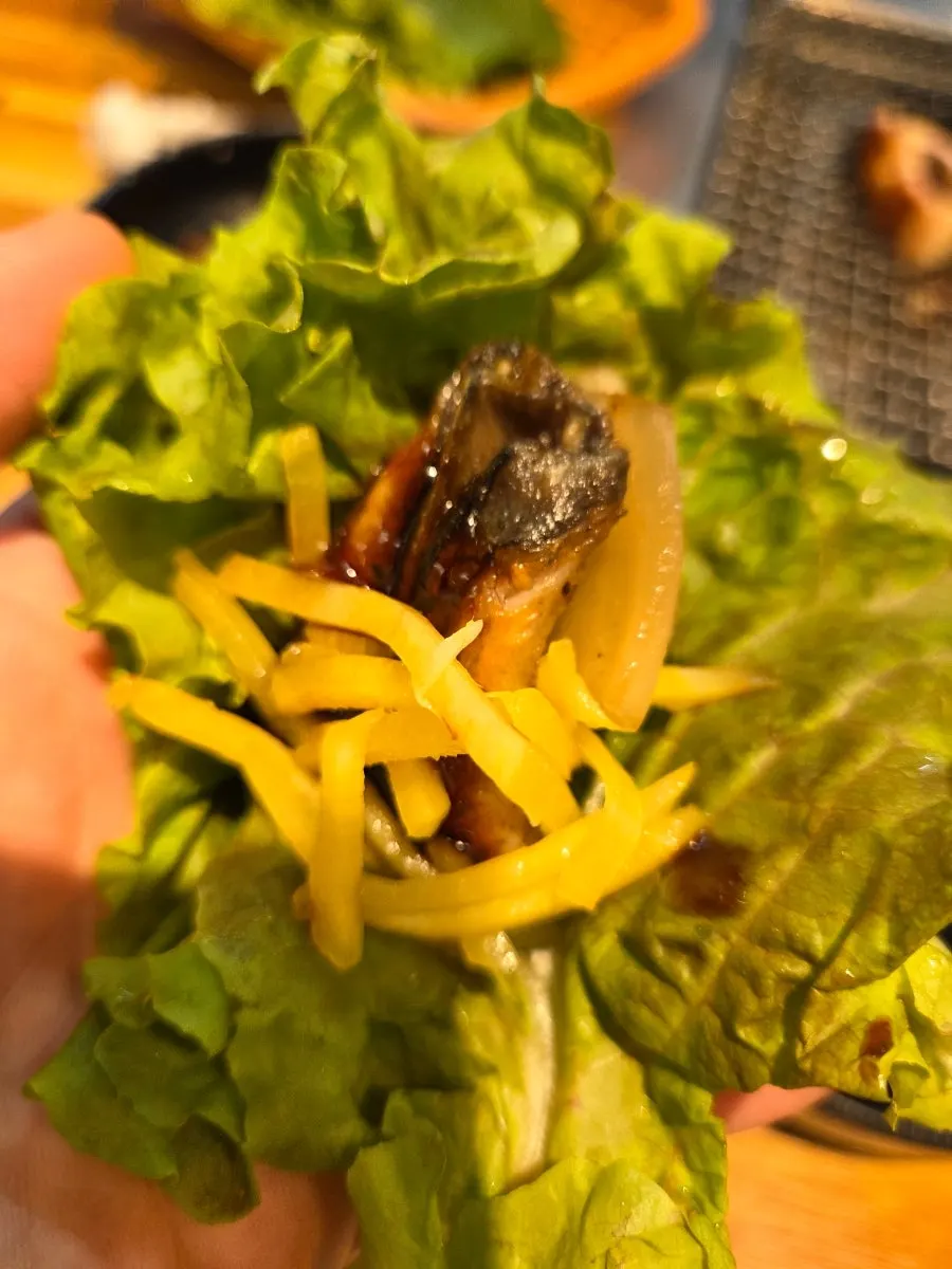 Wrap of eel and ginger strips on a pickled perilla leaf