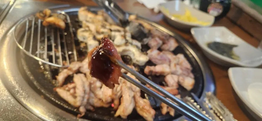 Grill topped with eel and pork belly