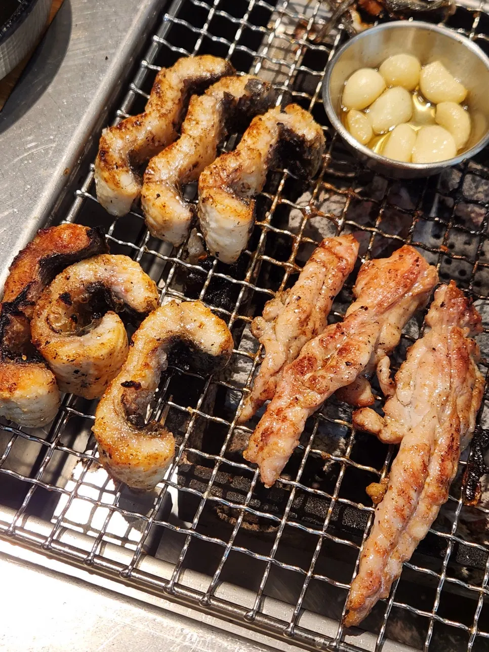 Grilled meat being picked up piece by piece
