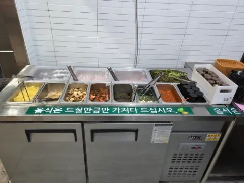 Self-service bar with vegetables and sauces