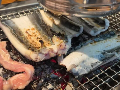 Pork belly and pork neck grilling over charcoal