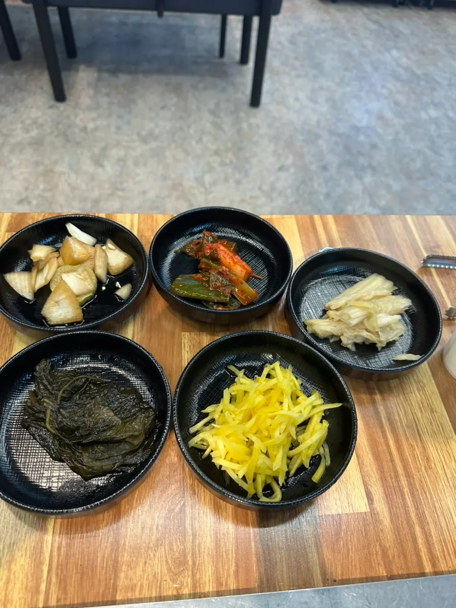 Self-serve corner stocked with side dishes and meat