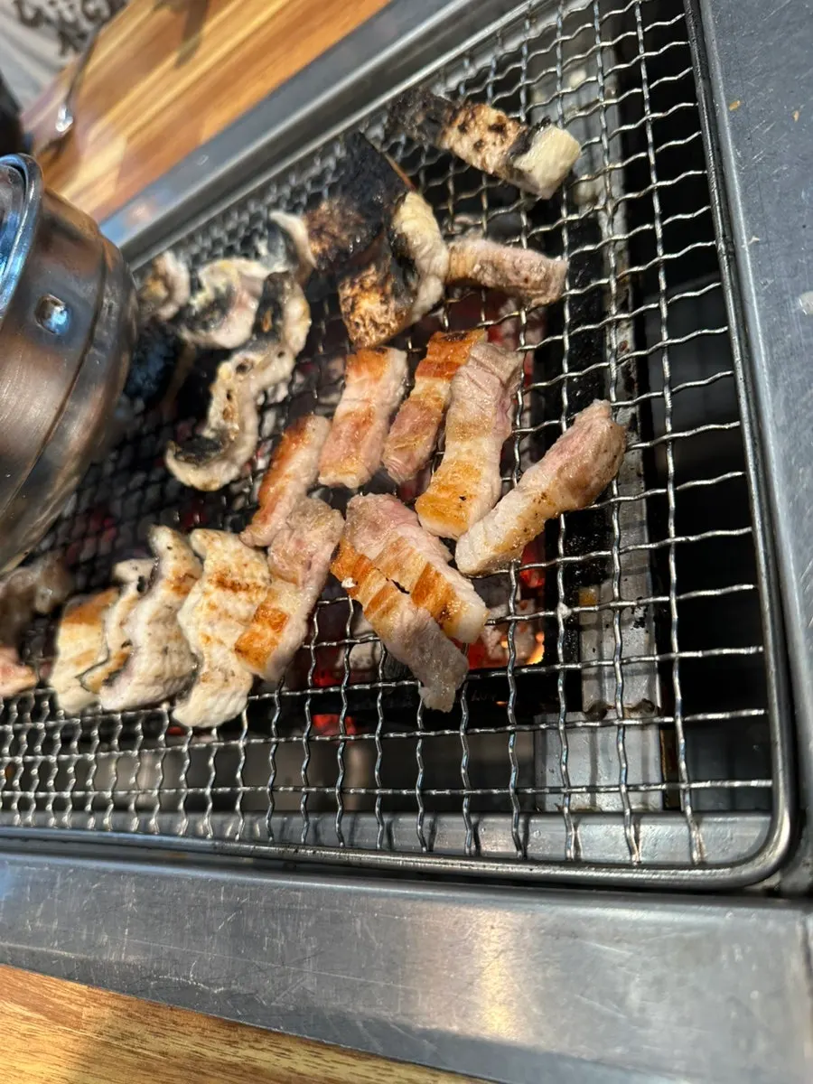 Freshwater eel placed skin-side down on the charcoal grill