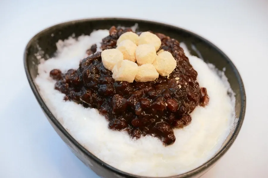 Milk red bean bingsu topped with red beans and injeolmi rice cake