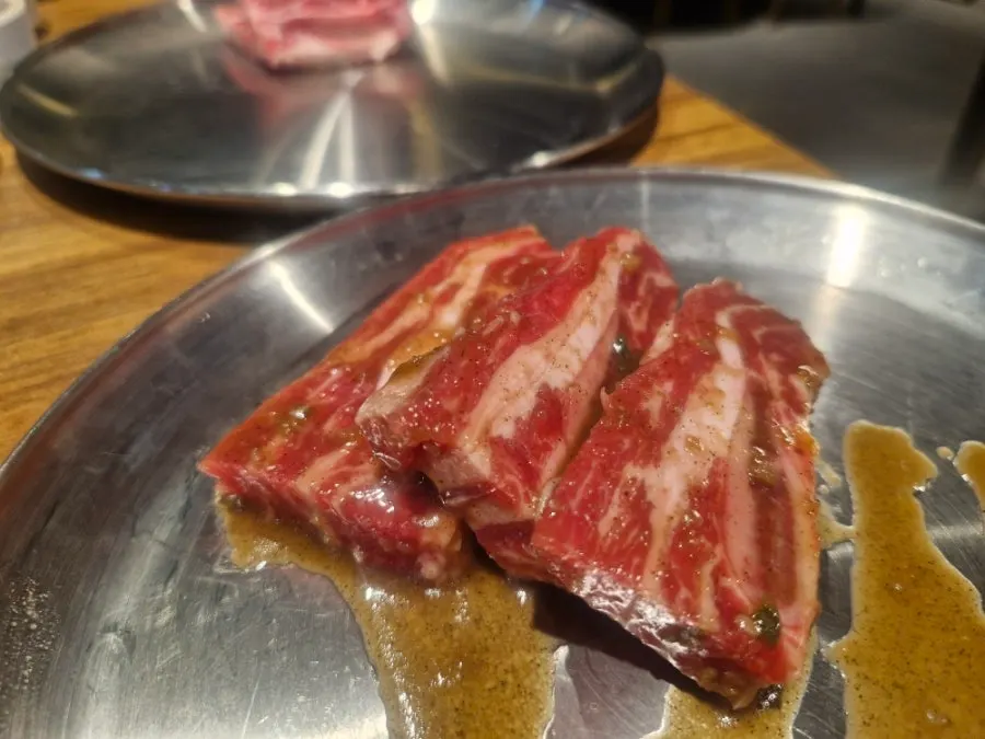 Raw and marinated LA galbi over the charcoal grill