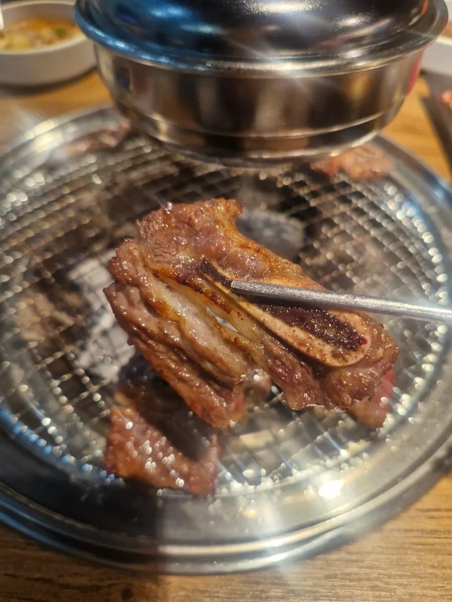 A piece of galbi topped with shiitake mushroom sauce