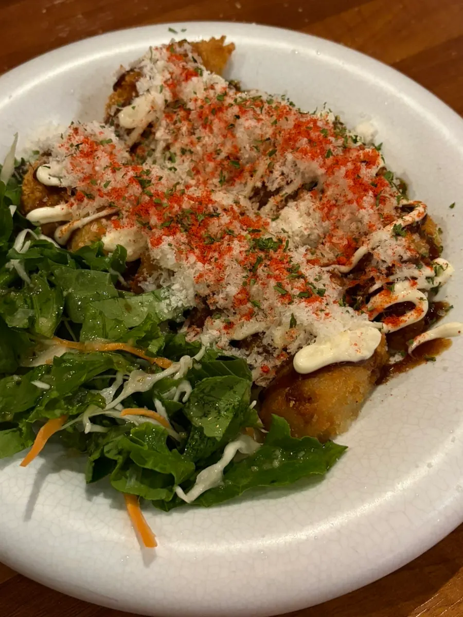 Croquette piled high with snow cheese, served with salad