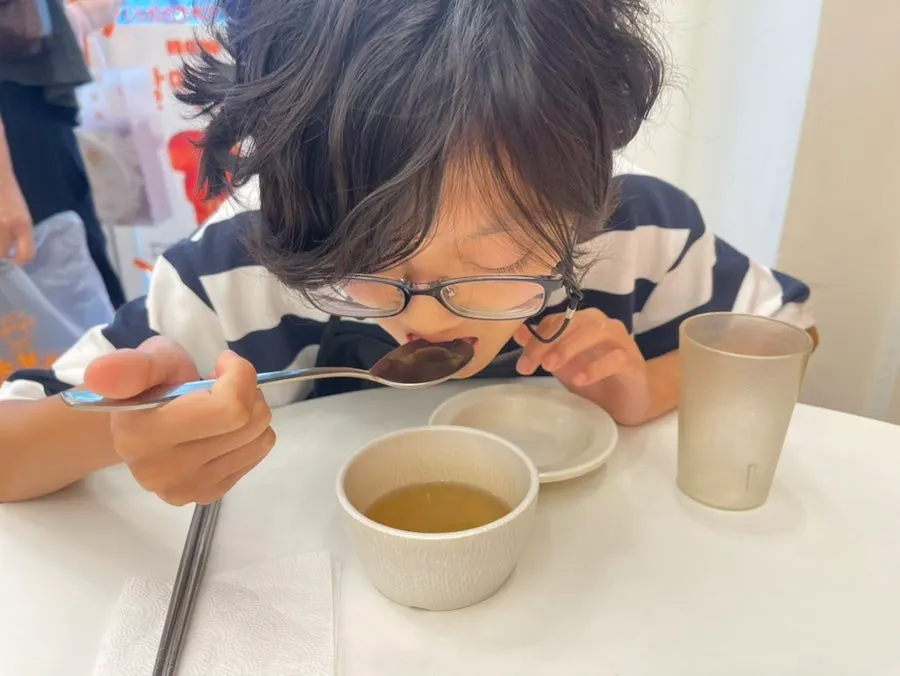 A warm bowl of broth served before the main order arrives
