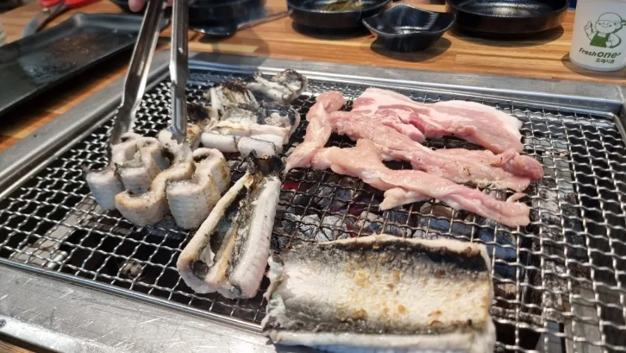 Plump eel grilling on a grill plate