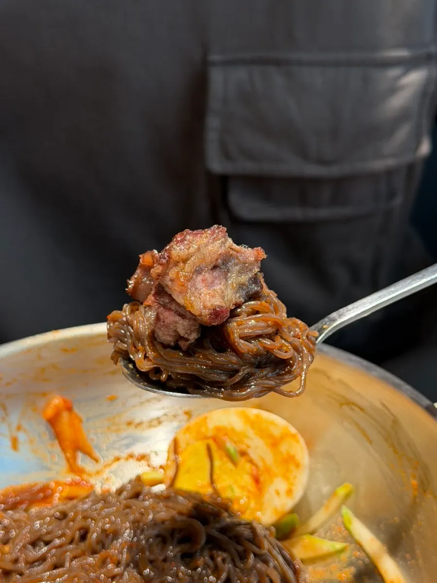 Bibim naengmyeon topped with flower rib