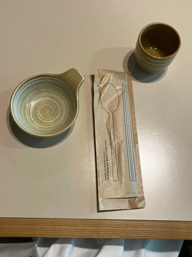 Basic table setting with wrapped utensils and water