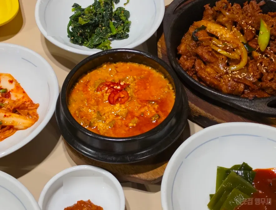 Full table spread with side dishes, mains and gondre rice