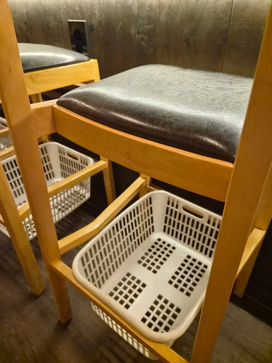 Bar-table seats and baskets for belongings