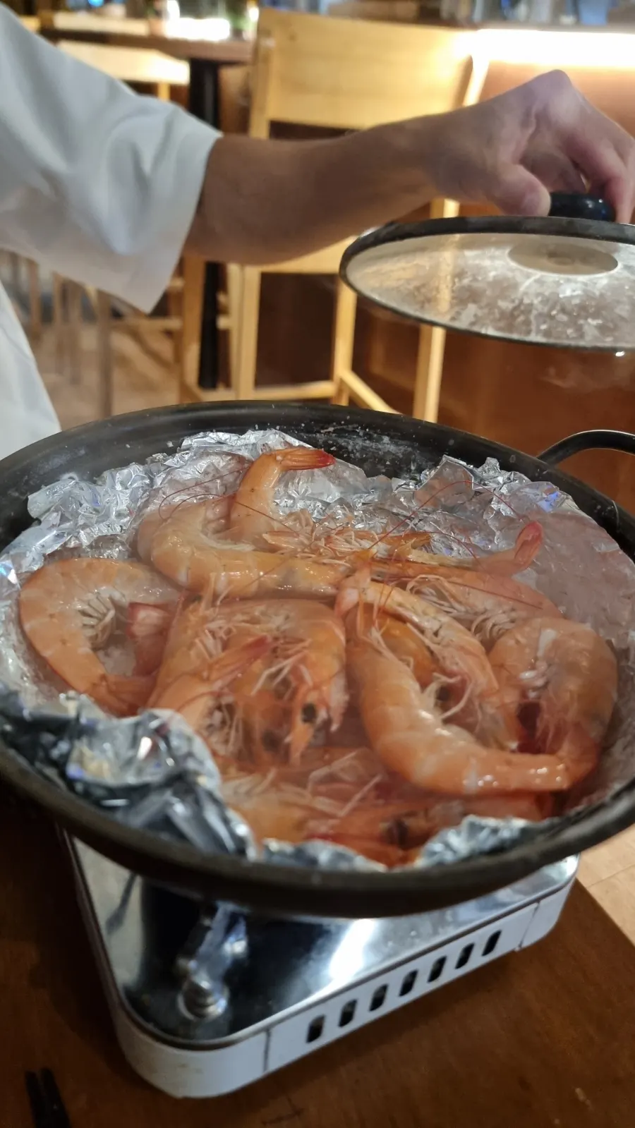 Seasonal raw shrimp grilled over coarse salt