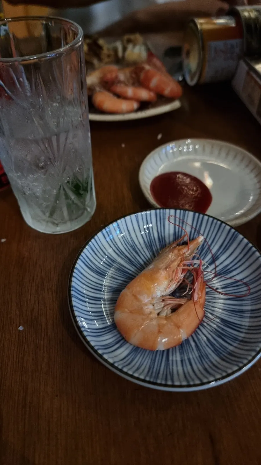 Eating seasonal raw shrimp while wearing gloves