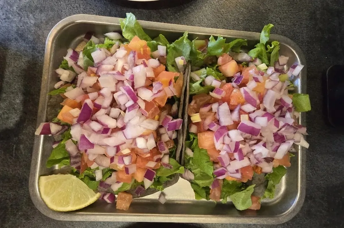 Birria taco served with lime