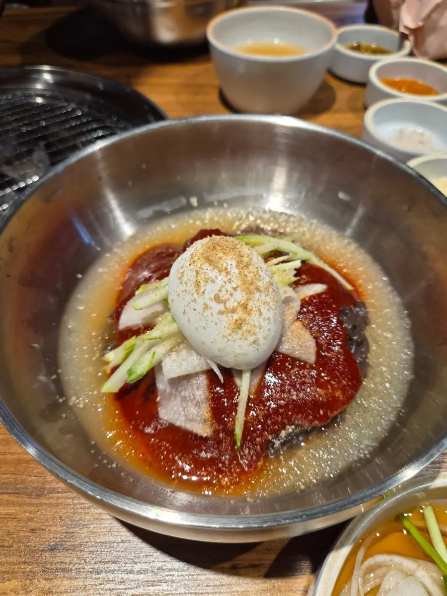Beef served with onion and bibim naengmyeon