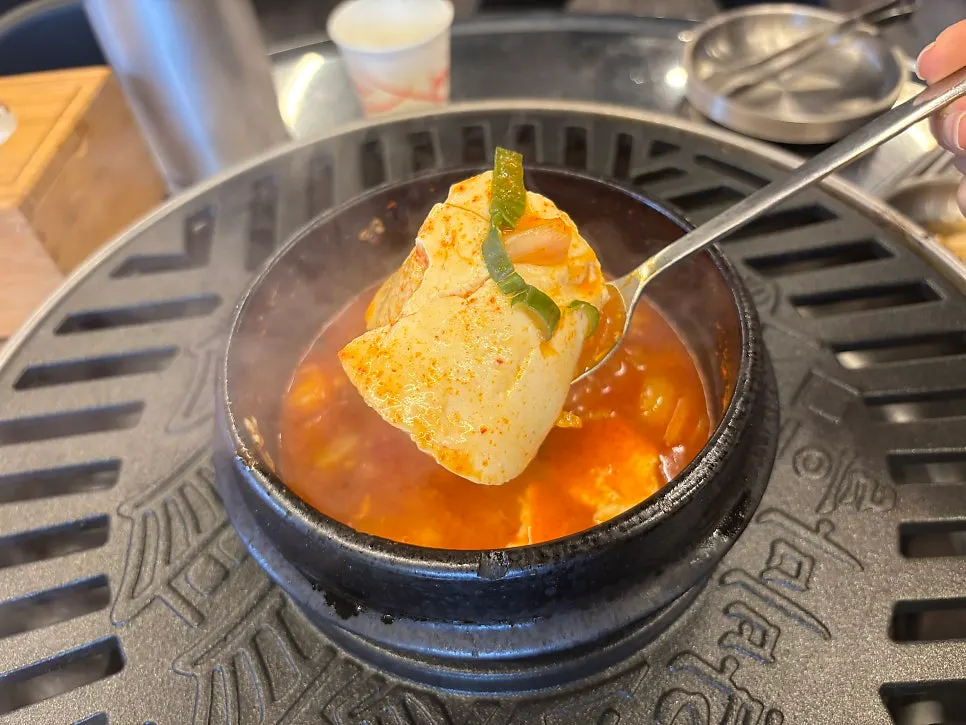 Bubbling soft tofu stew alongside jjokgalbi on the table