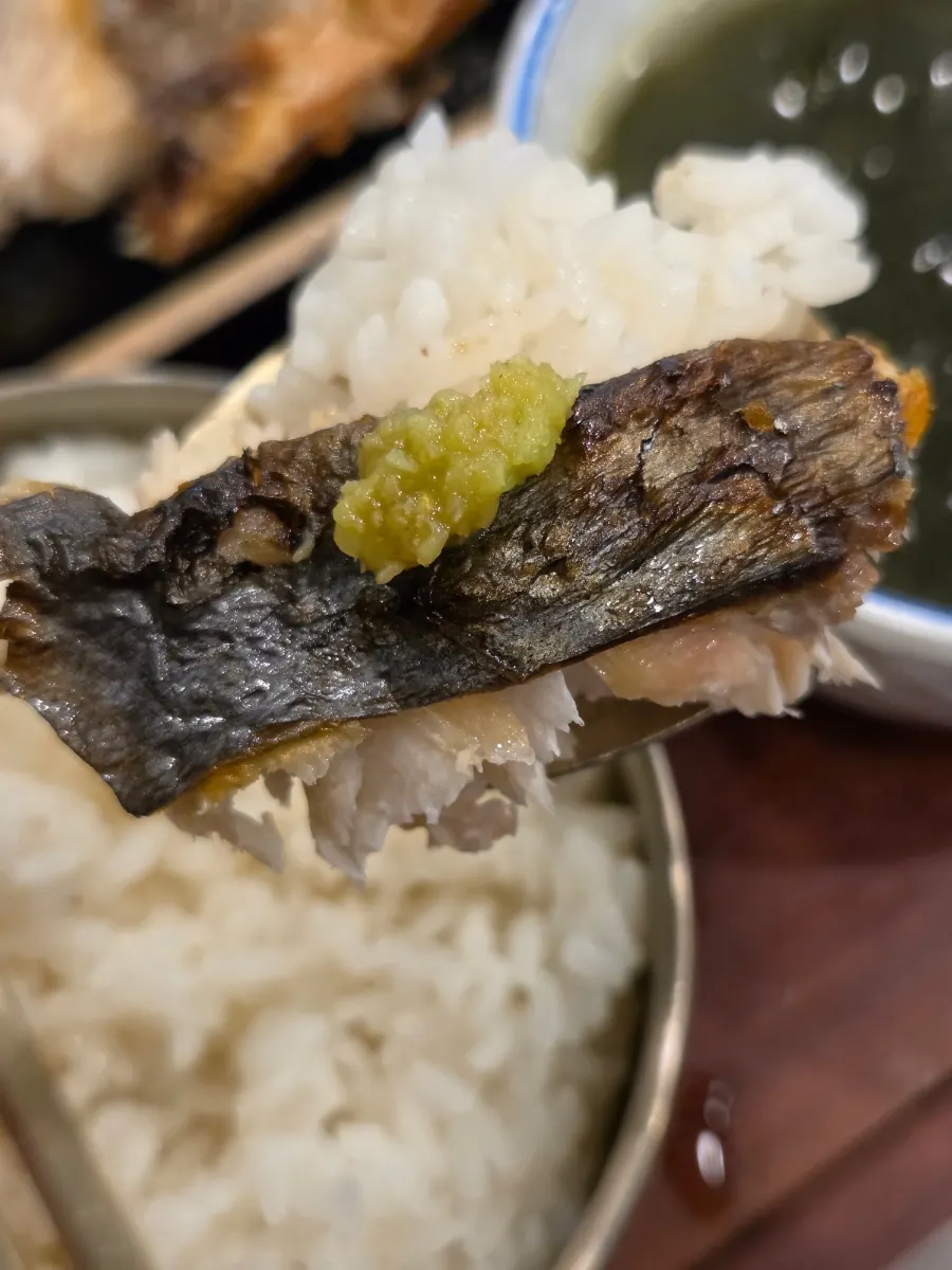 A bite of grilled Spanish mackerel with rice