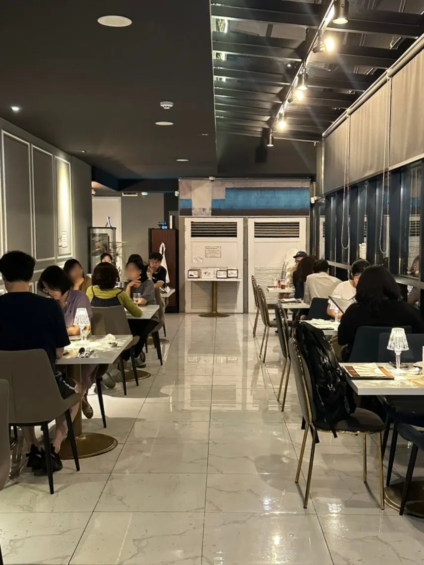 Restaurant entrance with a chandelier overhead