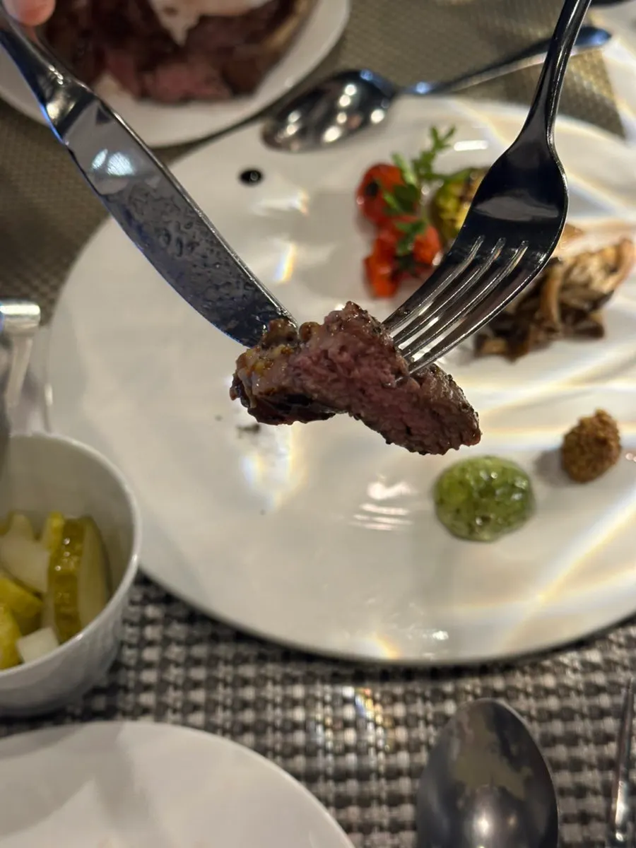 Medium-rare lamb chop steak with garnishes