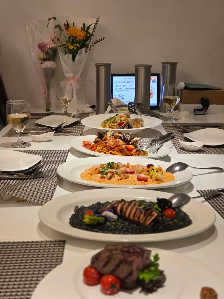Five dishes of pasta and risotto laid out on the table