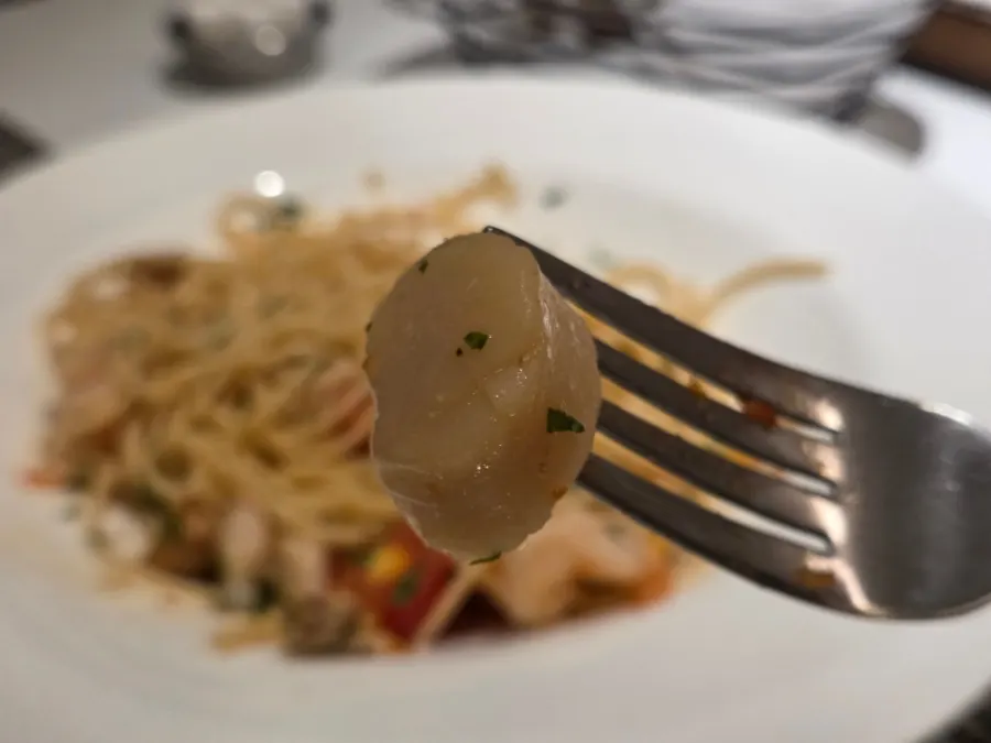 Close-up of tomato spaghetti sprinkled with grated cheese