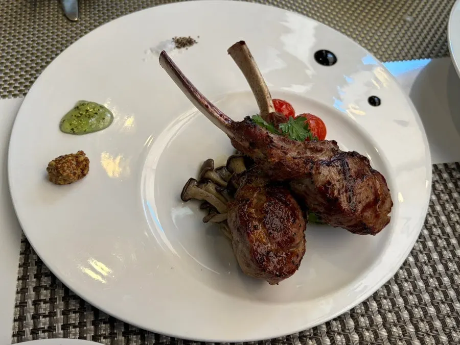 Plate of lamb rack steak grilled French rack style
