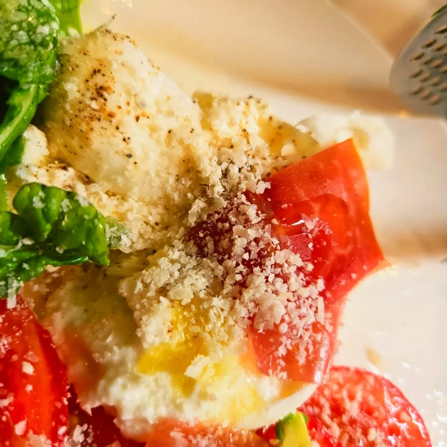 Salad plated with prosciutto and cherry tomatoes