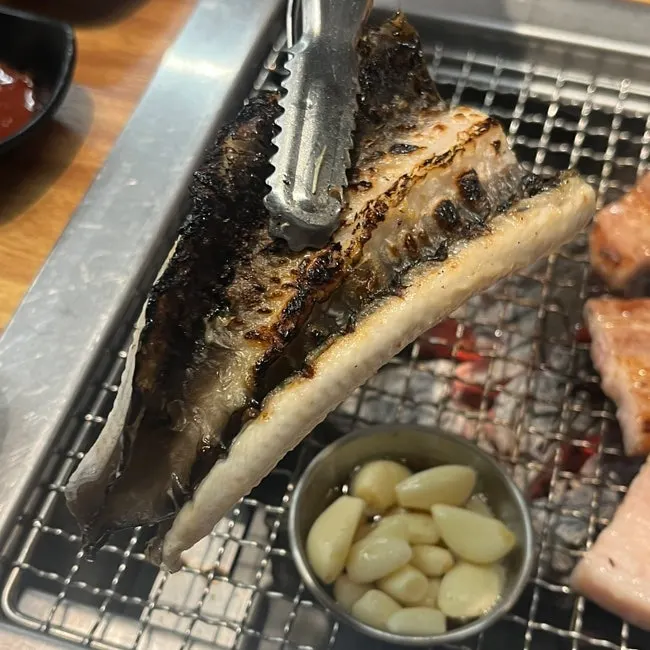 Freshwater eel turning golden brown on the grill